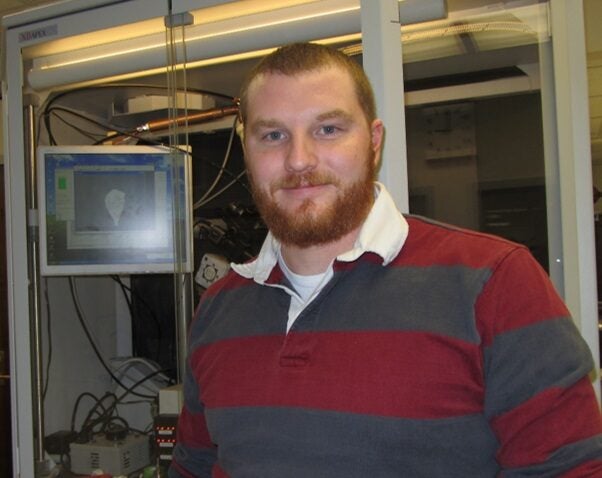 Image of Dr. Bertke in front of a diffractometer.